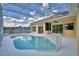 Inviting screened-in pool with ample deck space and beautiful backyard views, perfect for relaxing at 10708 Belo Horizonte Ave, Clermont, FL 34711