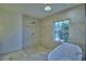 Walk-in shower and tub beneath a window, with custom-tiled walls, and bronze shower fixtures at 10708 Belo Horizonte Ave, Clermont, FL 34711