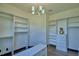 Bright walk-in closet with custom shelving, cabinets and center island for storage at 10708 Belo Horizonte Ave, Clermont, FL 34711