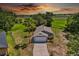 An aerial view shows the grey single-story home on a large lot at 1100 Lowry Ave # 63, Lakeland, FL 33801
