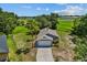 An aerial view shows the grey single-story home on a large lot at 1100 Lowry Ave # 63, Lakeland, FL 33801