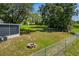 Fenced backyard featuring a fire pit and grassy area at 1100 Lowry Ave # 63, Lakeland, FL 33801