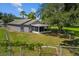 Fenced backyard featuring a fire pit and beautiful shade trees at 1100 Lowry Ave # 63, Lakeland, FL 33801