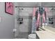 Tiled shower with updated fixtures and decorative shower curtain in renovated bathroom at 1100 Lowry Ave # 63, Lakeland, FL 33801