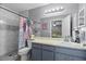 Bathroom with a tiled shower, vanity and view to bedroom at 1100 Lowry Ave # 63, Lakeland, FL 33801