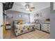 Cozy bedroom with a ceiling fan, tile floors, and dresser at 1100 Lowry Ave # 63, Lakeland, FL 33801