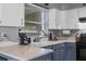 The kitchen features blue cabinets, white countertops, a stainless-steel faucet, and a window at 1100 Lowry Ave # 63, Lakeland, FL 33801