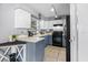 Cozy kitchen with blue cabinets, white countertops, and stainless-steel appliances offers a functional cooking space at 1100 Lowry Ave # 63, Lakeland, FL 33801