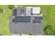 Aerial view of a home's roof highlighting solar panels and a covered outdoor patio at 1125 Rolling Woods Ln, Lakeland, FL 33813