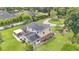 Expansive aerial view of the home featuring solar panels, lush backyard, and patio at 1125 Rolling Woods Ln, Lakeland, FL 33813