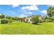 Backyard features lush green lawn, a covered patio, and tasteful landscaping for outdoor enjoyment at 1125 Rolling Woods Ln, Lakeland, FL 33813