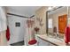 Bathroom with marble tile shower, dark accent tiles, updated vanity, and decorative butterflies on the wall at 1125 Rolling Woods Ln, Lakeland, FL 33813