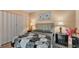 Relaxing bedroom with a queen-size bed, stylish lamps, and a coordinating dresser at 1125 Rolling Woods Ln, Lakeland, FL 33813