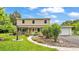 Charming two-story home with a well-manicured lawn, a welcoming front porch and lush landscaping at 1125 Rolling Woods Ln, Lakeland, FL 33813