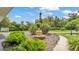 Landscaped front yard featuring a decorative fountain and a variety of lush plants and shrubbery at 1125 Rolling Woods Ln, Lakeland, FL 33813