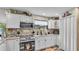 Well-lit kitchen featuring white cabinets, modern appliances, granite countertops, and decorative tile backsplash at 1125 Rolling Woods Ln, Lakeland, FL 33813