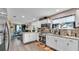Bright kitchen boasts white cabinets, modern appliances, granite countertops, and seamless flow to dining area at 1125 Rolling Woods Ln, Lakeland, FL 33813
