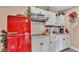 Charming kitchen with a retro-style refrigerator, white cabinets, and modern appliances at 1125 Rolling Woods Ln, Lakeland, FL 33813