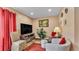 Cozy living room featuring a large screen TV, comfortable seating, and decorative accents at 1125 Rolling Woods Ln, Lakeland, FL 33813