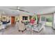 Bright living room boasts hardwood floors, contemporary furnishings, and a sliding glass door to the backyard at 1125 Rolling Woods Ln, Lakeland, FL 33813