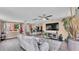 Bright living room boasts hardwood floors, contemporary furnishings, and a view of the kitchen at 1125 Rolling Woods Ln, Lakeland, FL 33813