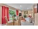 Inviting living room with a glass table, comfortable chairs, and large windows for natural light at 1125 Rolling Woods Ln, Lakeland, FL 33813