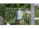 An aerial view of a house with mature trees, a driveway, and a partial view of a road at 124 Tyler St, Lake Wales, FL 33859