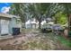 Spacious backyard with mature trees, sheds, and space for outdoor activities and entertainment at 124 Tyler St, Lake Wales, FL 33859