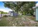 Spacious backyard with mature trees, sheds, and space for outdoor activities and entertainment at 124 Tyler St, Lake Wales, FL 33859