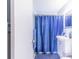 Compact bathroom featuring a blue shower curtain, white vanity, and blue accents at 124 Tyler St, Lake Wales, FL 33859