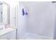 Bright bathroom featuring a tub, shower, vanity with storage, and tiled walls at 124 Tyler St, Lake Wales, FL 33859