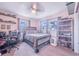 This bedroom has carpet, two windows, shelves, and a ceiling fan at 124 Tyler St, Lake Wales, FL 33859