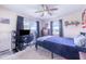 Cozy bedroom featuring a ceiling fan, carpeted floors, and natural light from the windows at 124 Tyler St, Lake Wales, FL 33859