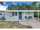 Inviting front porch with seating, blue door, white railing, and charming curb appeal at 124 Tyler St, Lake Wales, FL 33859