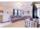 Cozy living area with neutral tones, a leather sofa set and lots of natural light at 124 Tyler St, Lake Wales, FL 33859