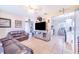 Spacious living room with tile flooring, a large leather sofa, and an open view to the kitchen at 124 Tyler St, Lake Wales, FL 33859
