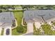 Aerial view of a home with well-maintained landscaping, a driveway, and a peaceful residential setting at 13 Enclave Dr, Winter Haven, FL 33884