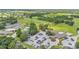 A high angle of a community with tennis courts, a pool, green space, golf course and parking at 13 Enclave Dr, Winter Haven, FL 33884