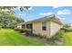 A well-kept backyard with a lush green lawn and manicured landscaping at 13 Enclave Dr, Winter Haven, FL 33884