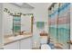 Fresh bathroom with decorative mirror, complemented by a vibrant shower curtain at 13 Enclave Dr, Winter Haven, FL 33884
