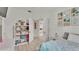 Stylish bedroom boasts tile floors, a comfortable bed, and built-in shelving for ample storage at 13 Enclave Dr, Winter Haven, FL 33884