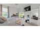 Well-lit bedroom with modern decor, including a large TV and access to a screened lanai at 13 Enclave Dr, Winter Haven, FL 33884