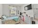 Bright bedroom with tile flooring, a flat-screen TV, and a well-organized vanity at 13 Enclave Dr, Winter Haven, FL 33884
