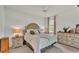 Bright bedroom featuring a tufted headboard, neutral color palette, and natural light at 13 Enclave Dr, Winter Haven, FL 33884