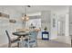 Open dining area with a round table and chairs, seamlessly connected to the kitchen at 13 Enclave Dr, Winter Haven, FL 33884