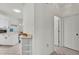 Hallway that flows into the kitchen featuring white cabinets and lots of natural light at 13 Enclave Dr, Winter Haven, FL 33884