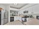 Well-lit kitchen features white cabinets and view to dining area for easy serving at 13 Enclave Dr, Winter Haven, FL 33884