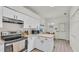 This kitchen showcases white cabinets and stainless steel appliances, perfect for cooking at 13 Enclave Dr, Winter Haven, FL 33884