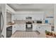 Bright kitchen featuring white cabinets, stainless steel appliances, and neutral countertops at 13 Enclave Dr, Winter Haven, FL 33884