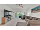 Relaxing living room features comfortable sofa and recliner, an entertainment center, and a lanai view at 13 Enclave Dr, Winter Haven, FL 33884